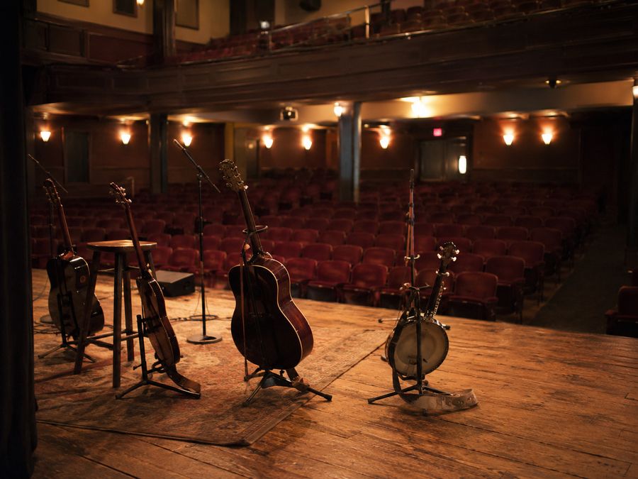 Acoustic instruments set on a theatre stage before a country date